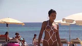 Sexy baby in daring string bikini on the beach