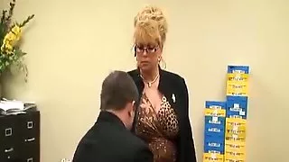 Tall mature lady in office with  her foot slave
